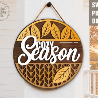 Cozy Season round door sign SVG with layered autumn leaves and knit pattern texture, laser cut file for fall wood decor