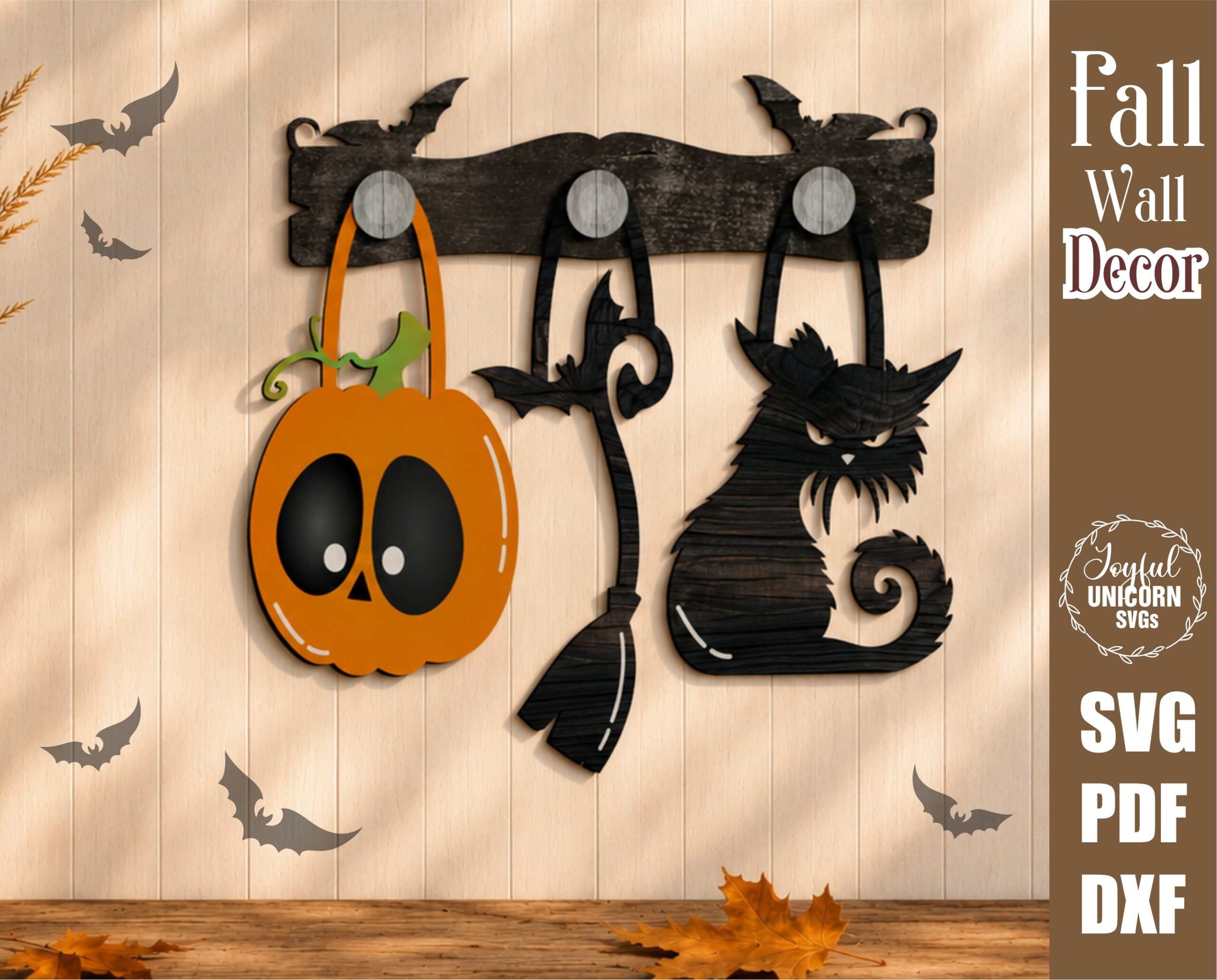 Interchangeable Halloween wall decor SVG with a pumpkin, witch broom, and spooky black cat hanging from wooden hooks on a decorative bat display bar, laser cut file for Glowforge, CNC machines, and other lasers.