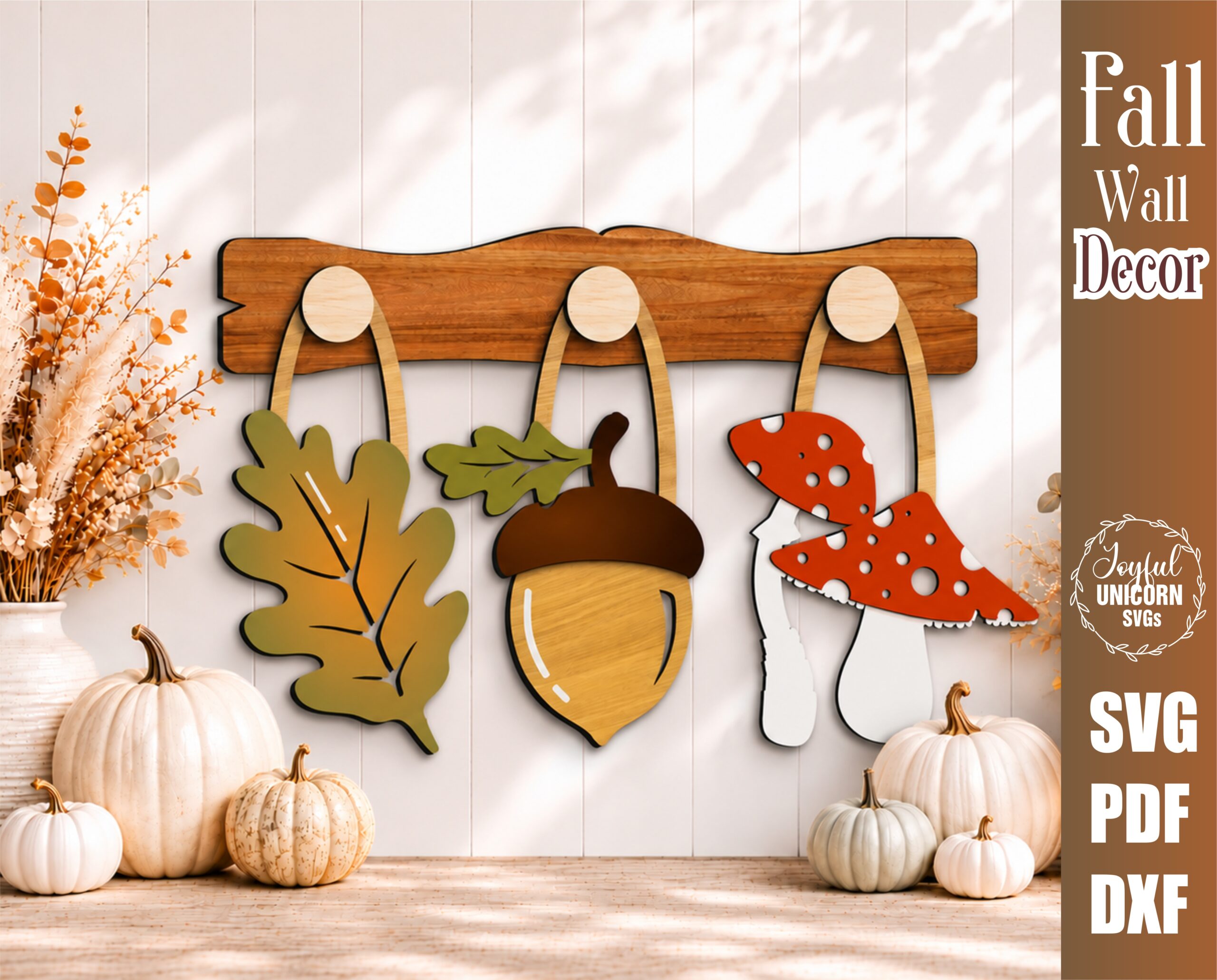 Interchangeable fall wall decor SVG with oak leaf, acorn, and mushroom hanging from wooden hooks on a decorative wooden display bar, laser cut file for Glowforge, CNC machines, and other lasers.